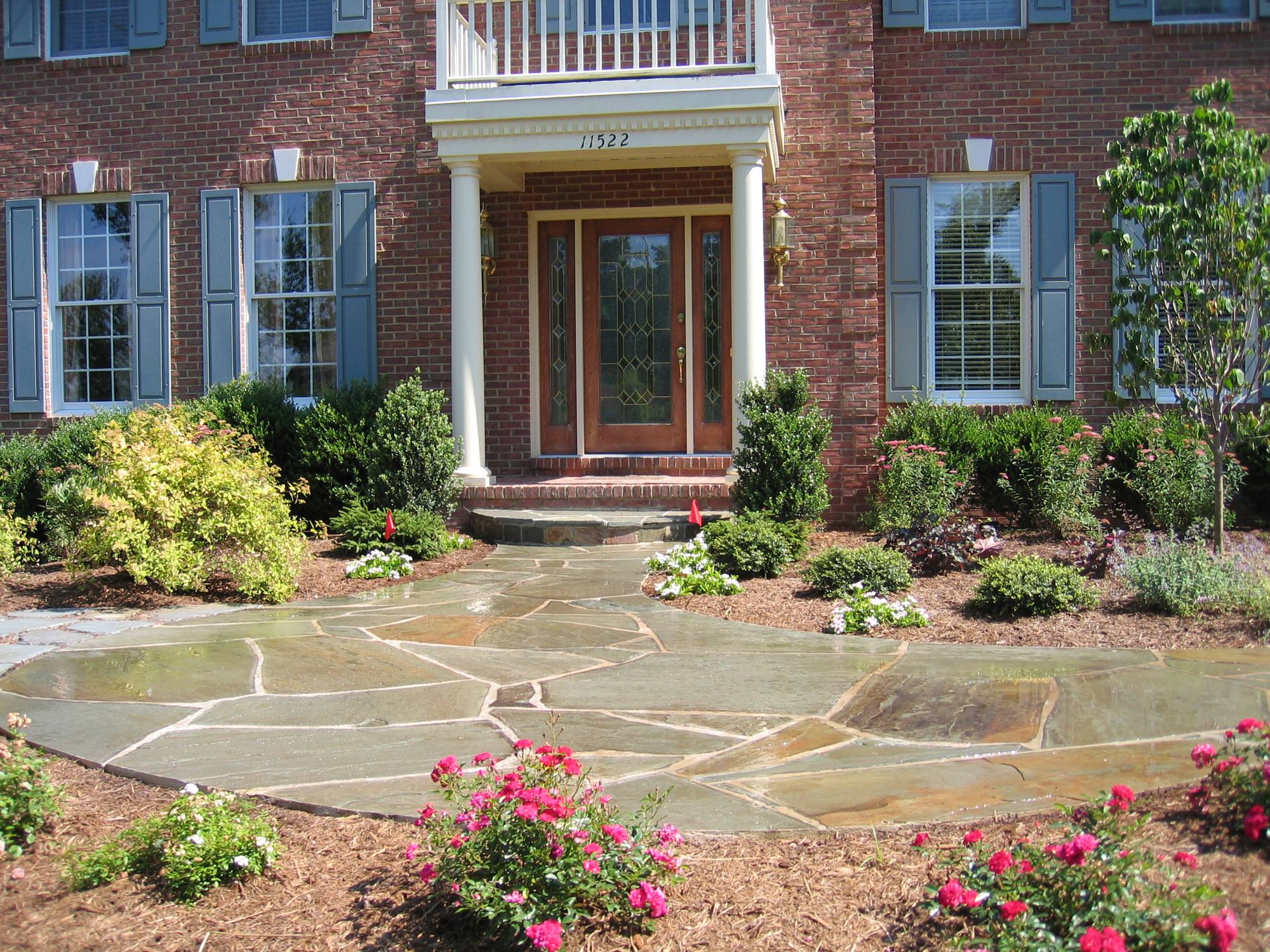 Flagstone entry walkway and landing with rose beds at a Northern Virginia home