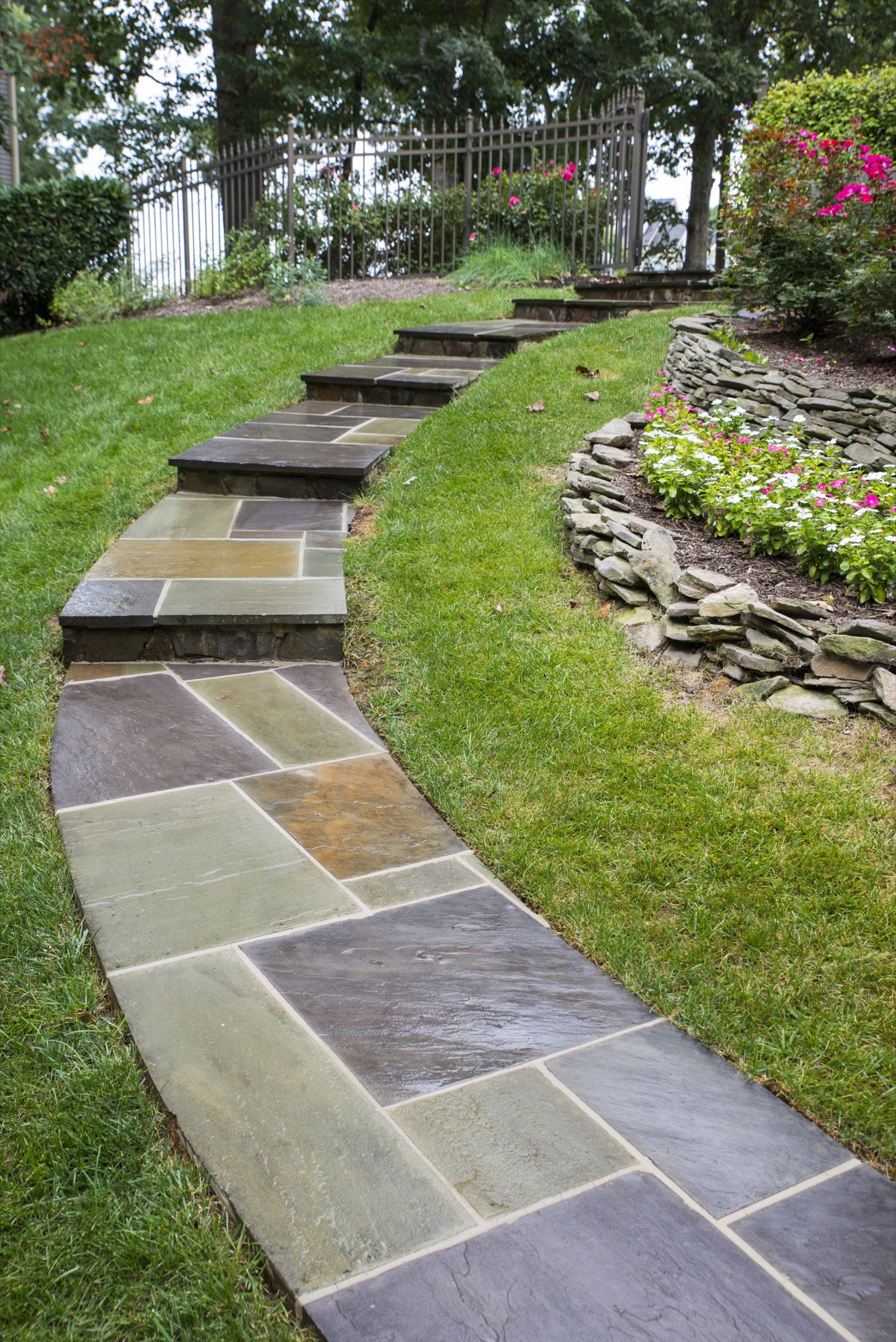 Flagstone walkway with natural stone steps up a sloped yard in Northern Virginia