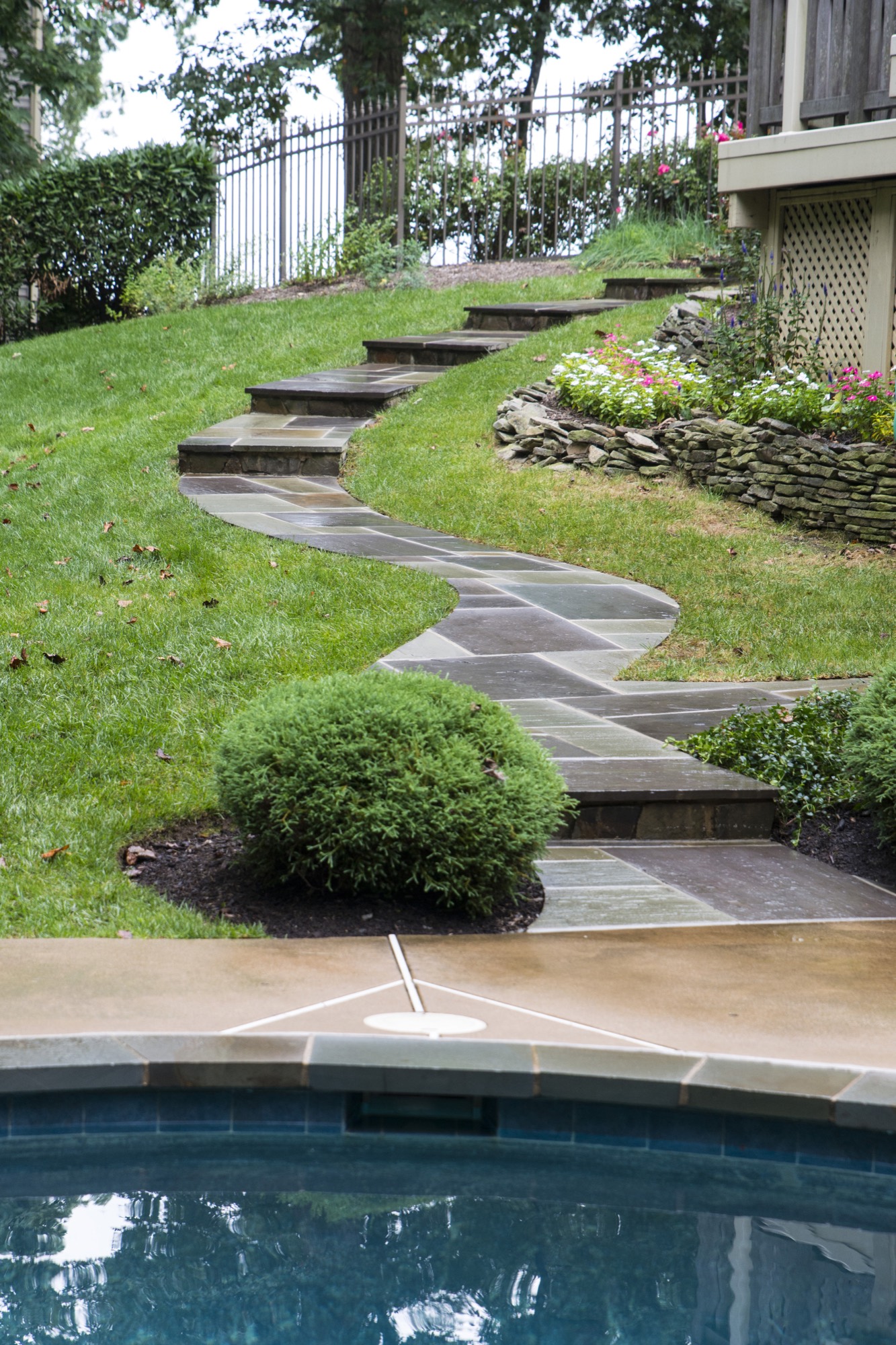 Natural stone steps leading down to a pool in Northern Virginia