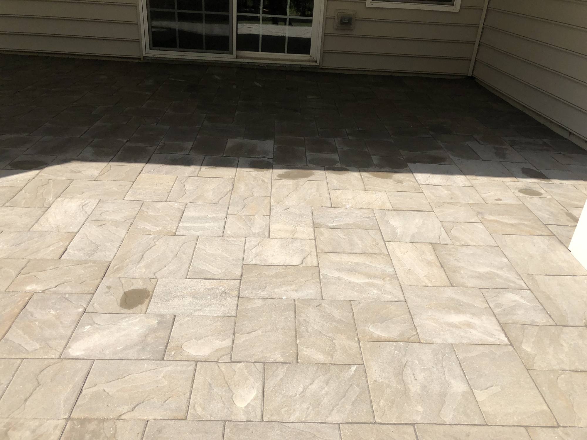 Large-format paver patio beneath an elevated deck in Northern Virginia