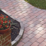 Example of a red brick patio with a garden surrounding it